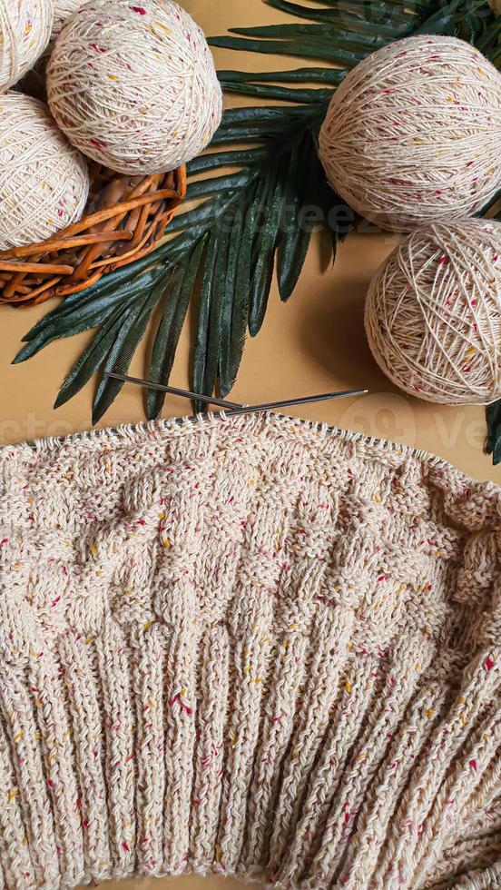 Knitted handmade items. Knitted fabric from colored thread. Bright background. photo