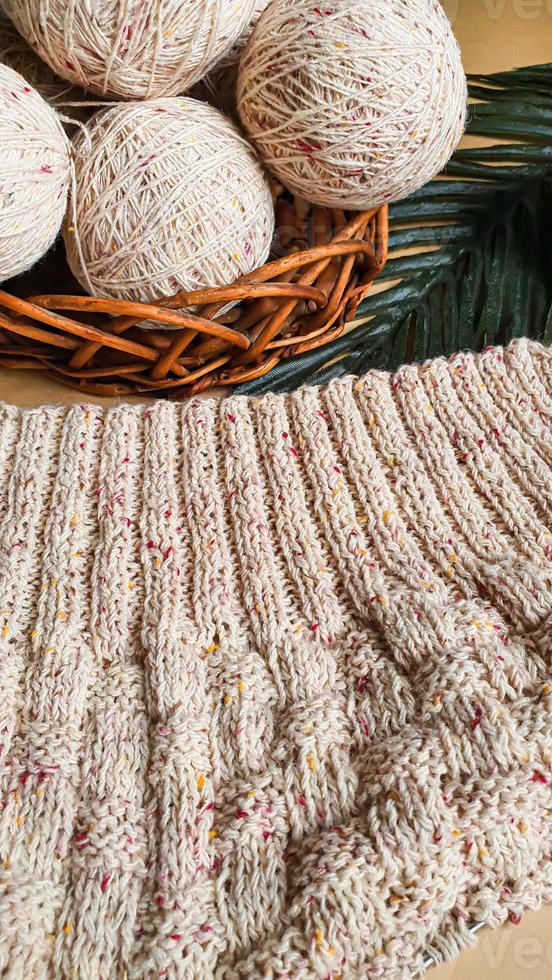 Knitted handmade items. Knitted fabric from colored thread. Bright background. photo
