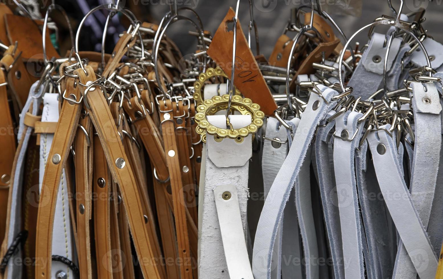 Leather belts in a market photo