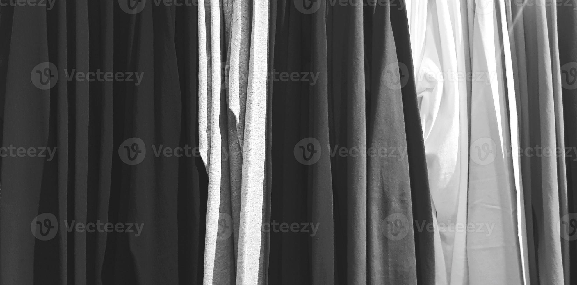 Art pattern of clothing, cotton or fabric hanging in line at fashion store in black and white style for background photo