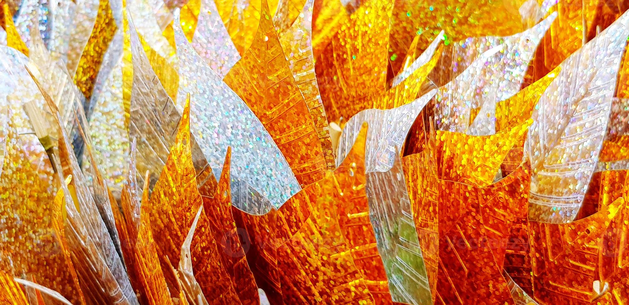 Close up silver and golden leaves for background at Thai temple. Group of object for respect holy, monk statue. Pattern of colorful leaf wallpaper photo