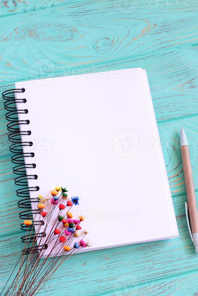 Open blank notebook on wooden table photo