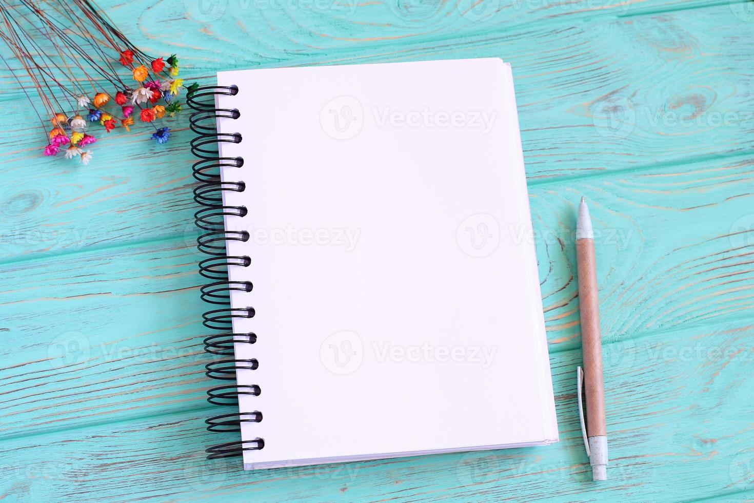 Open blank notebook on wooden table photo