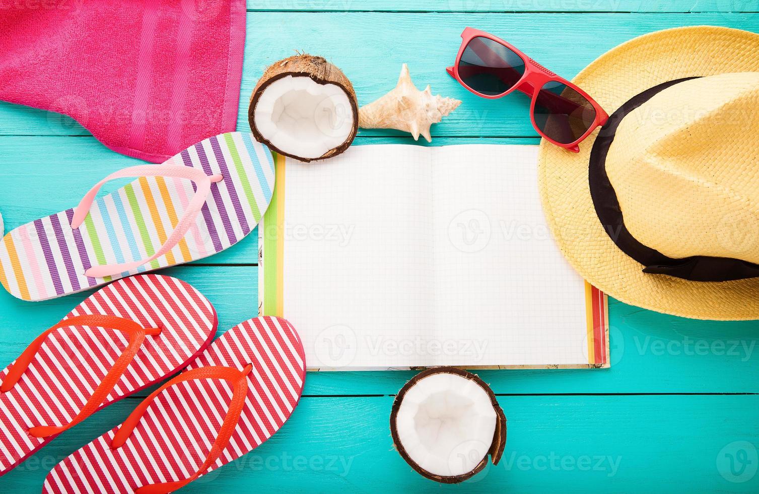 Summer accessories for modern woman on her vacation. Top view. Blue wooden background with copy space. photo