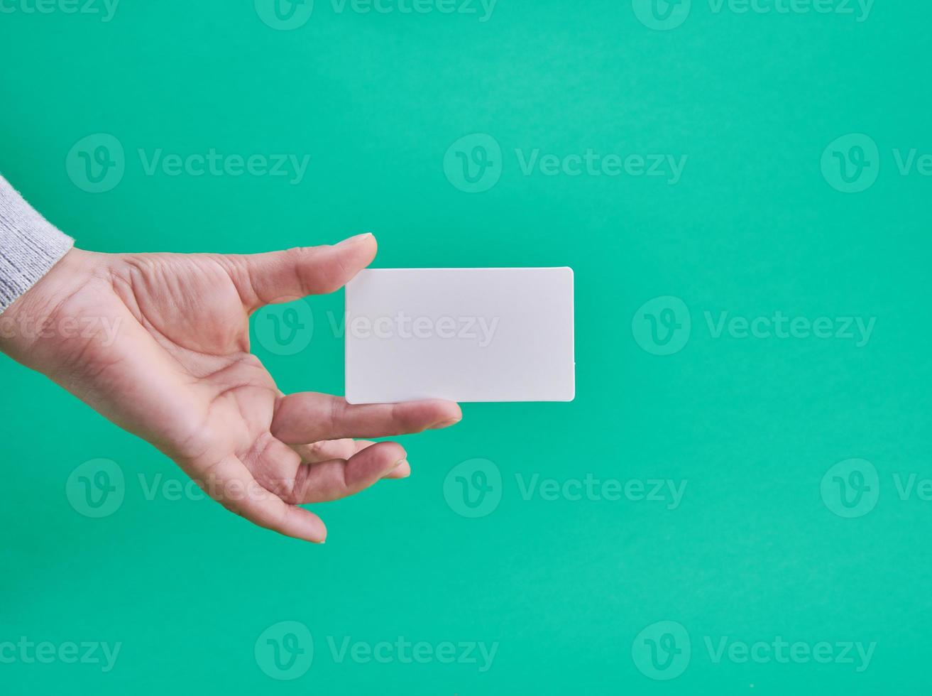 white paper business card in a female hand photo