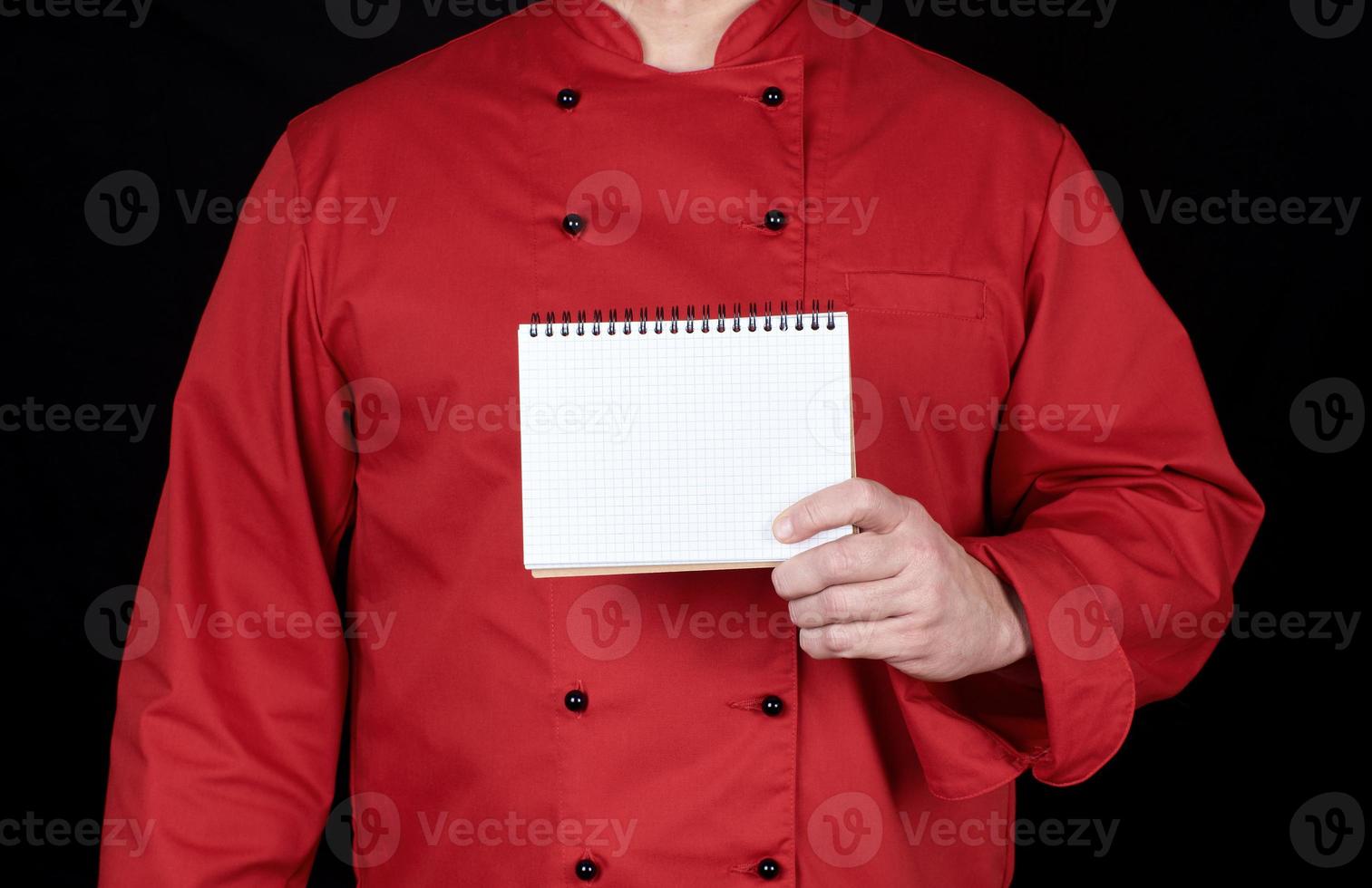 chef in red uniform  holding a blank notebook photo