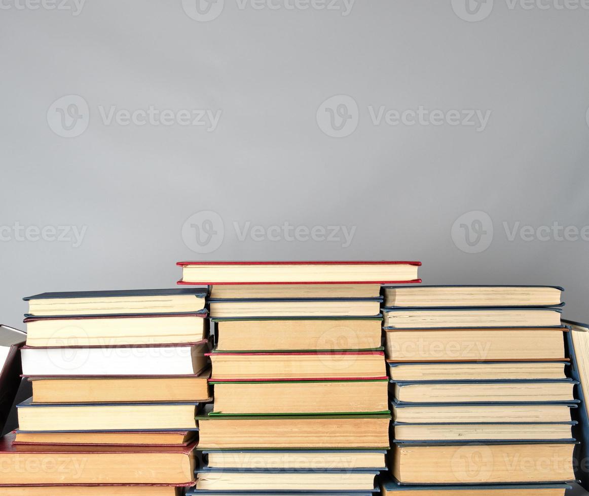 stack of different books on a gray background photo