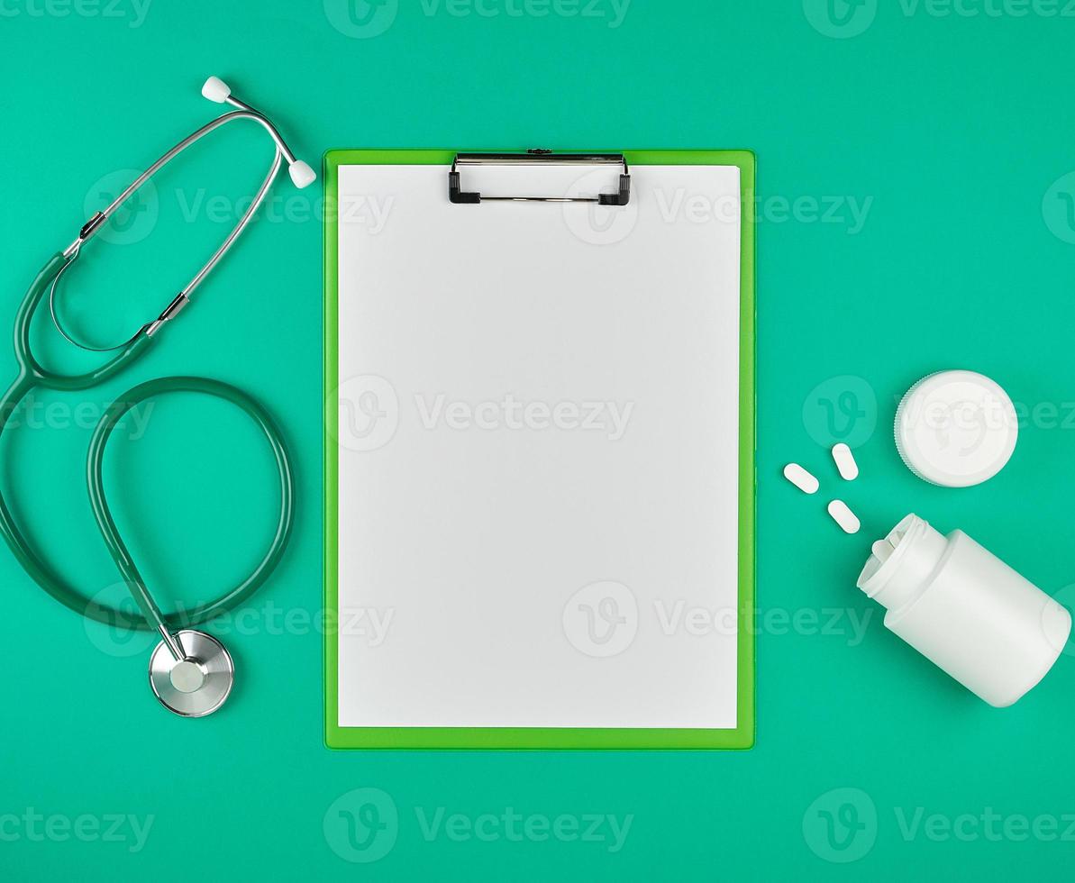 paper holder with empty white sheets, medical stethoscope photo