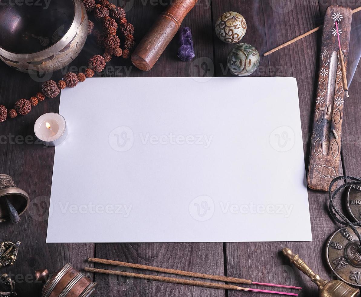 blank white sheet in the middle of religious objects for meditation photo