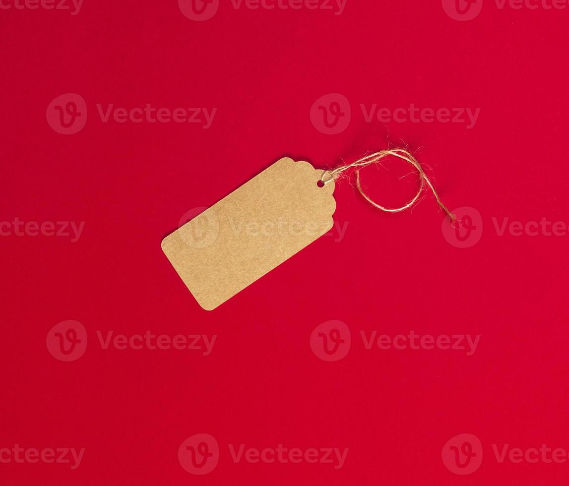 empty brown paper tag for clothes on a rope photo
