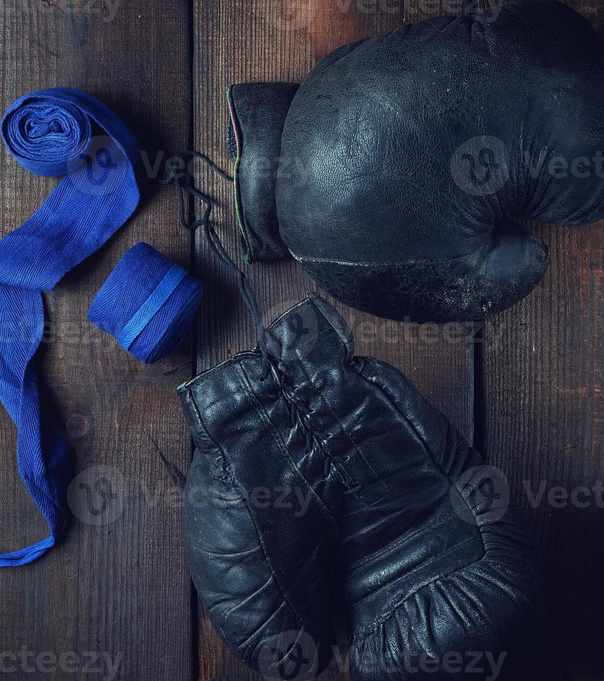 pair of very old black leather boxing gloves photo