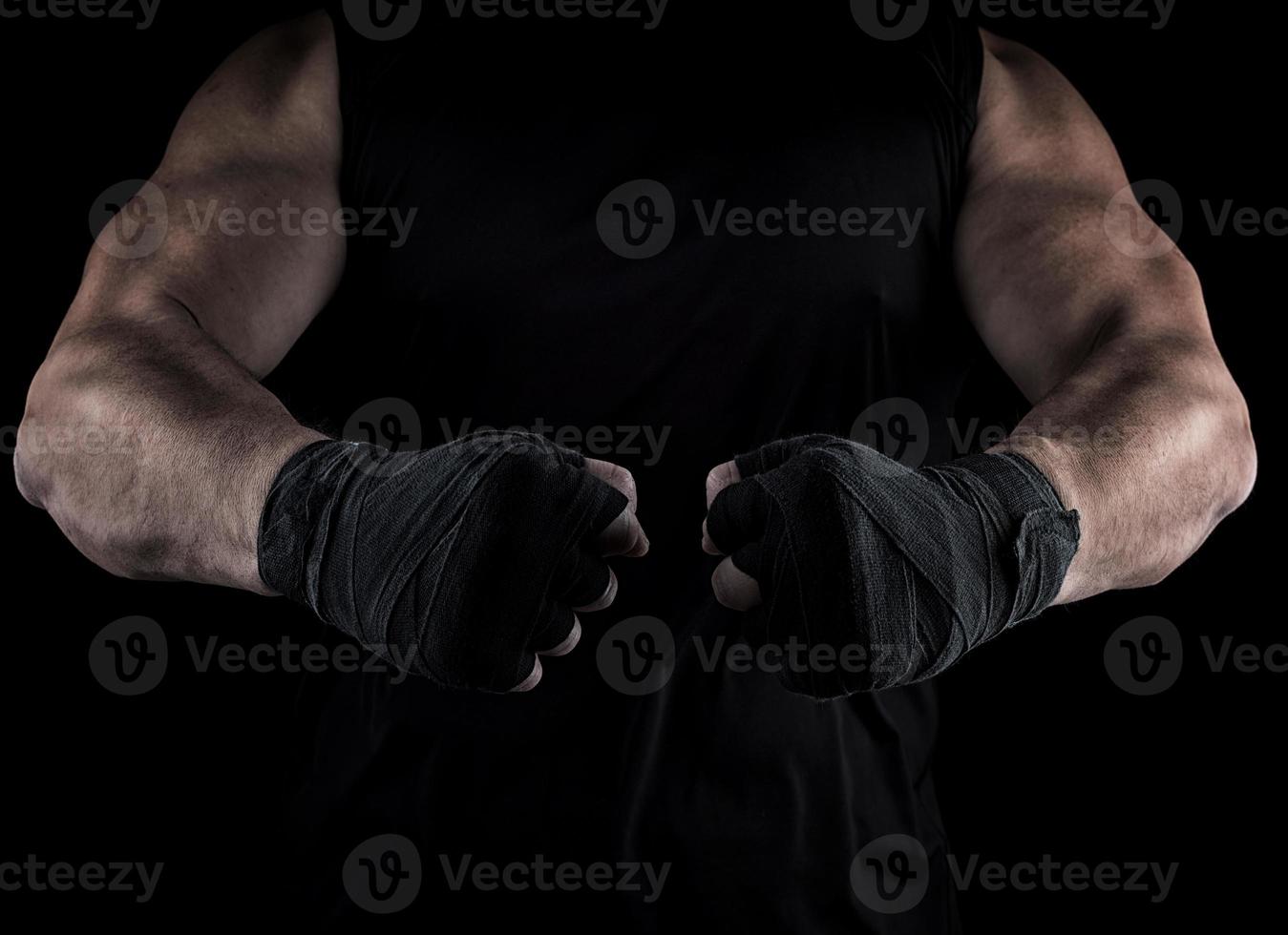 two men's hands wrapped in a black bandage, body parts in front of the torso photo