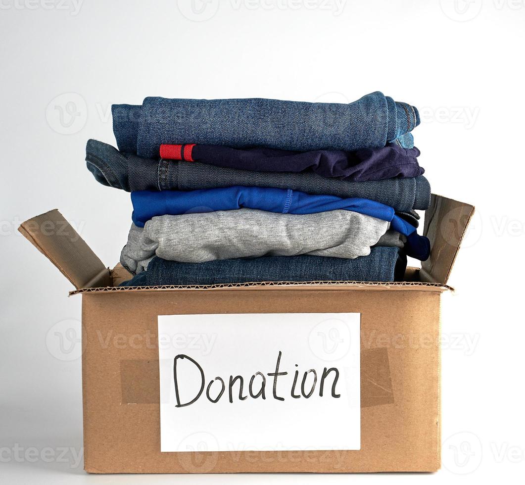 folded clothes in a brown paper box with the inscription donation photo