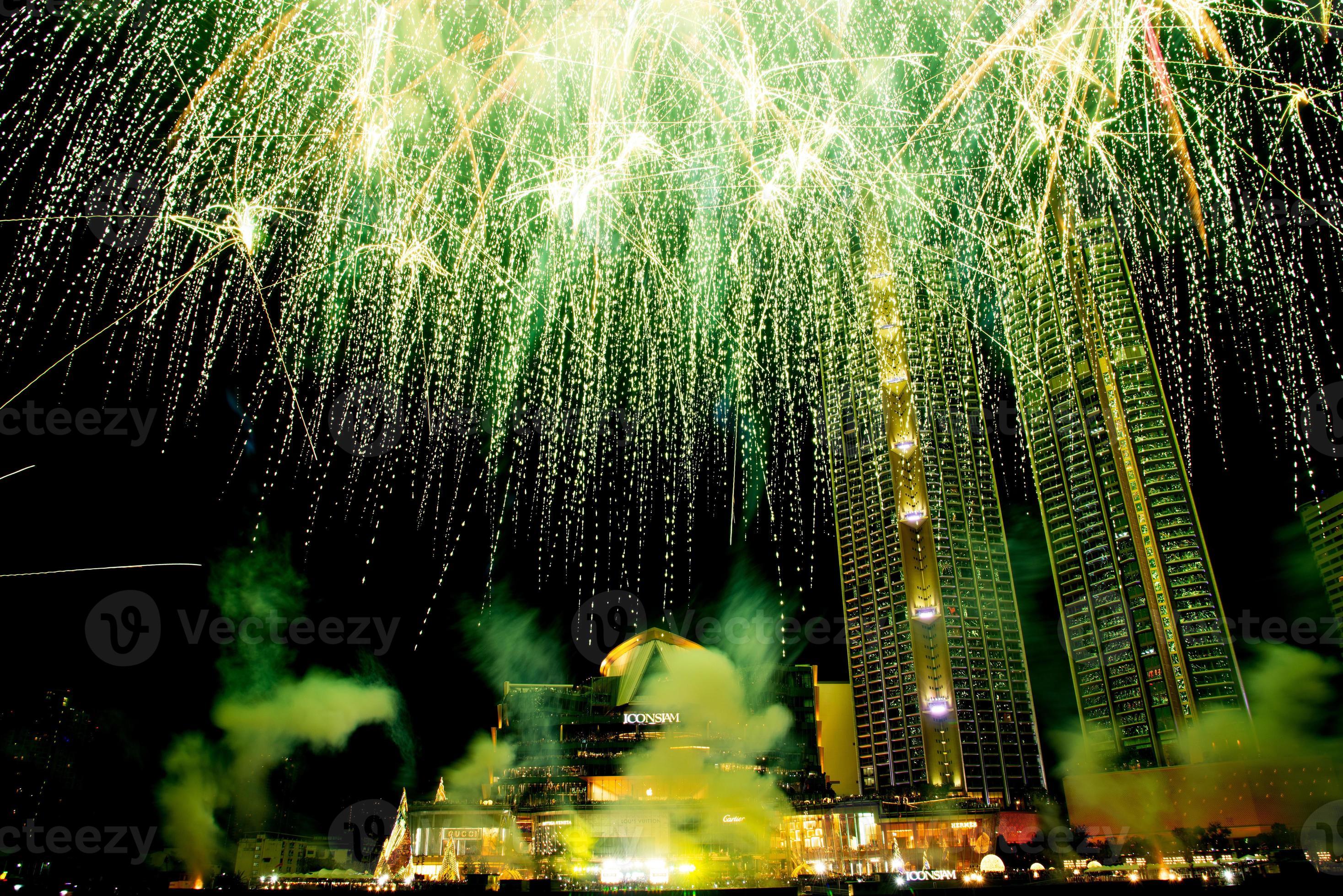 New year celebrate, crowd and colorful fireworks near the river