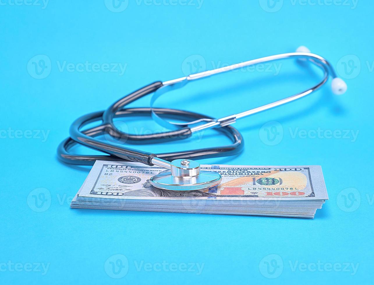 paper money and a medical stethoscope photo