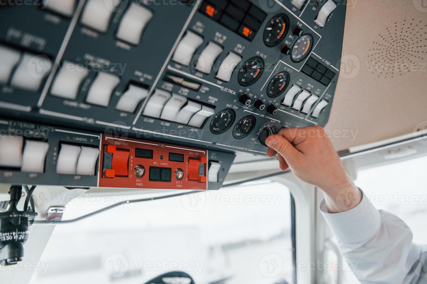 Close up view. Pilot on the work in the passenger airplane. Preparing for takeoff photo