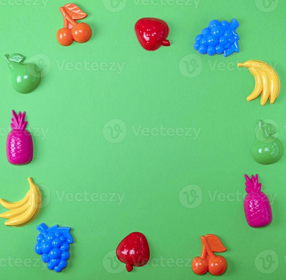 green background with childrens colorful toys photo