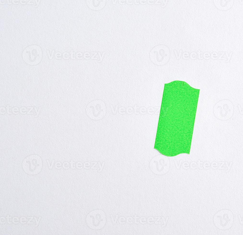 empty white sheet of paper and green paper sticky tape to write the cost of goods photo