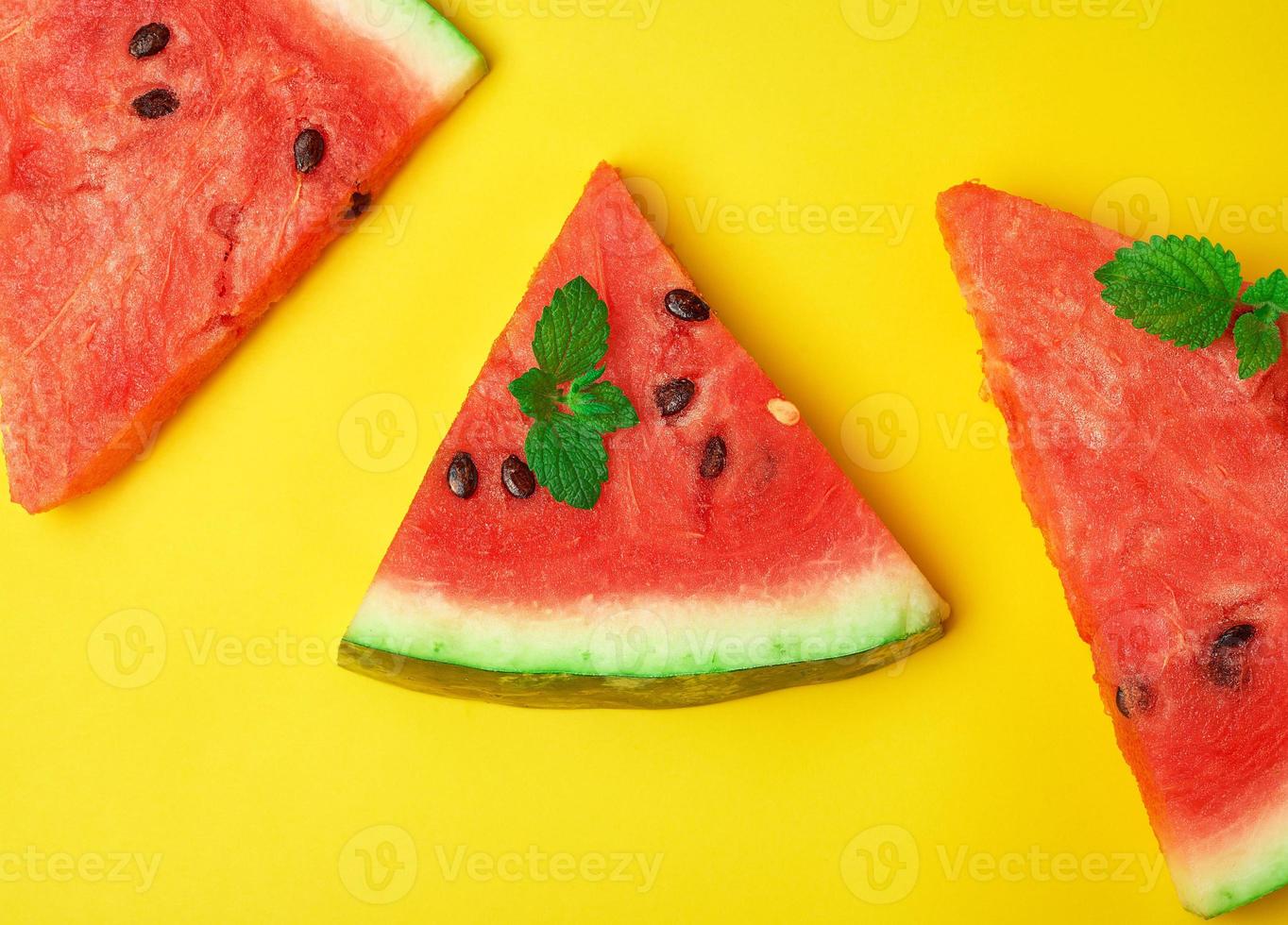triangular slices of ripe red watermelon with seeds photo