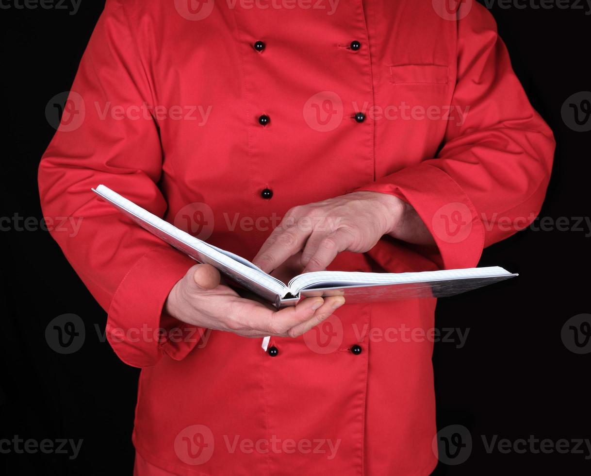 chef in red uniform holding open notepad photo