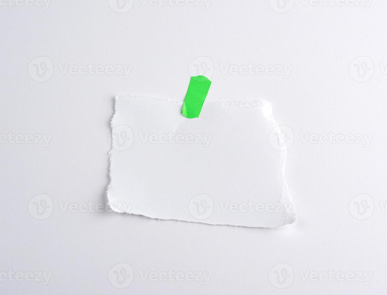 torn off white piece of paper glued to green velcro photo