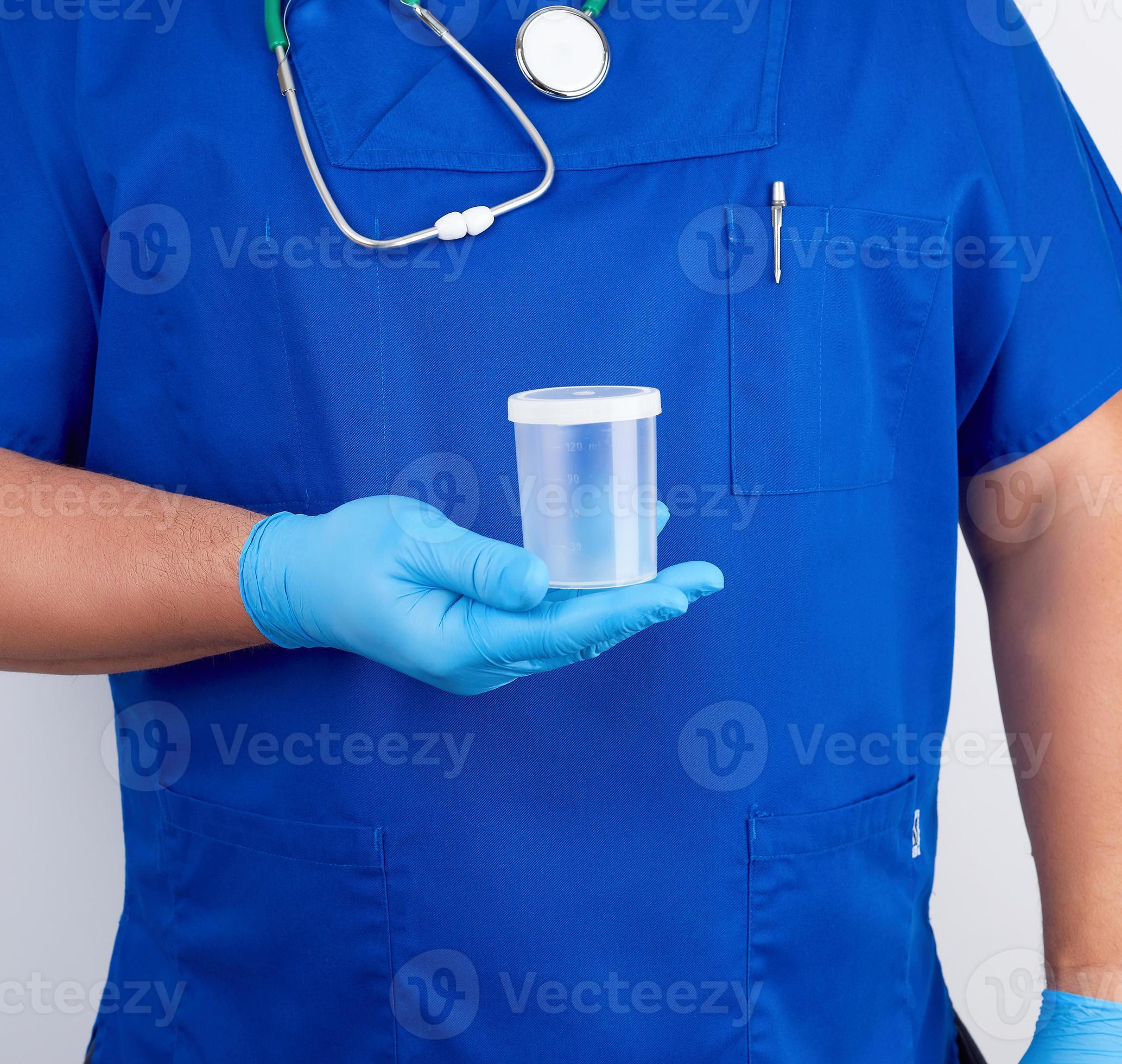 doctor in blue uniform and latex gloves is holding an empty plastic