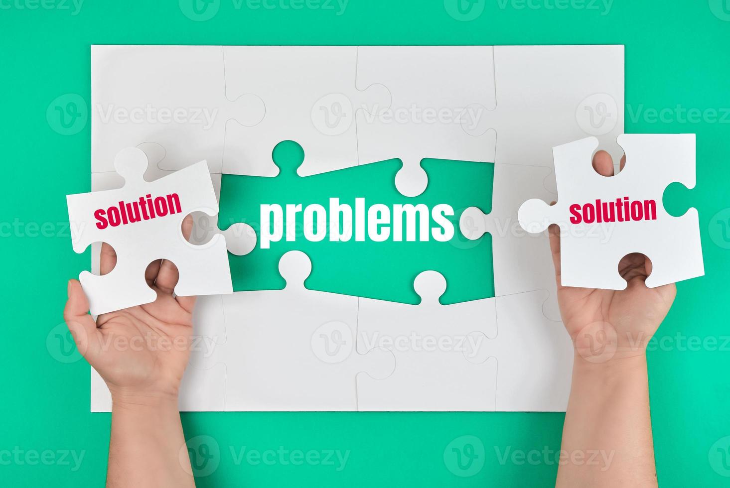 female hand holding white puzzle with the word solution, process of closing the missing element with the word problem photo