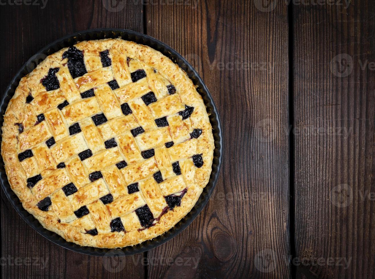 baked round black currant cake photo