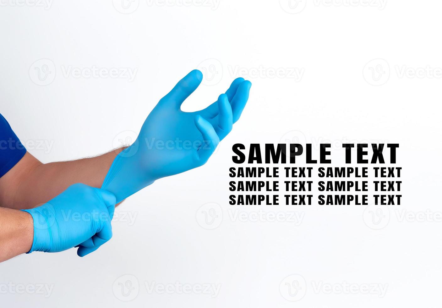 two male hands in blue medical sterile gloves on a white background photo