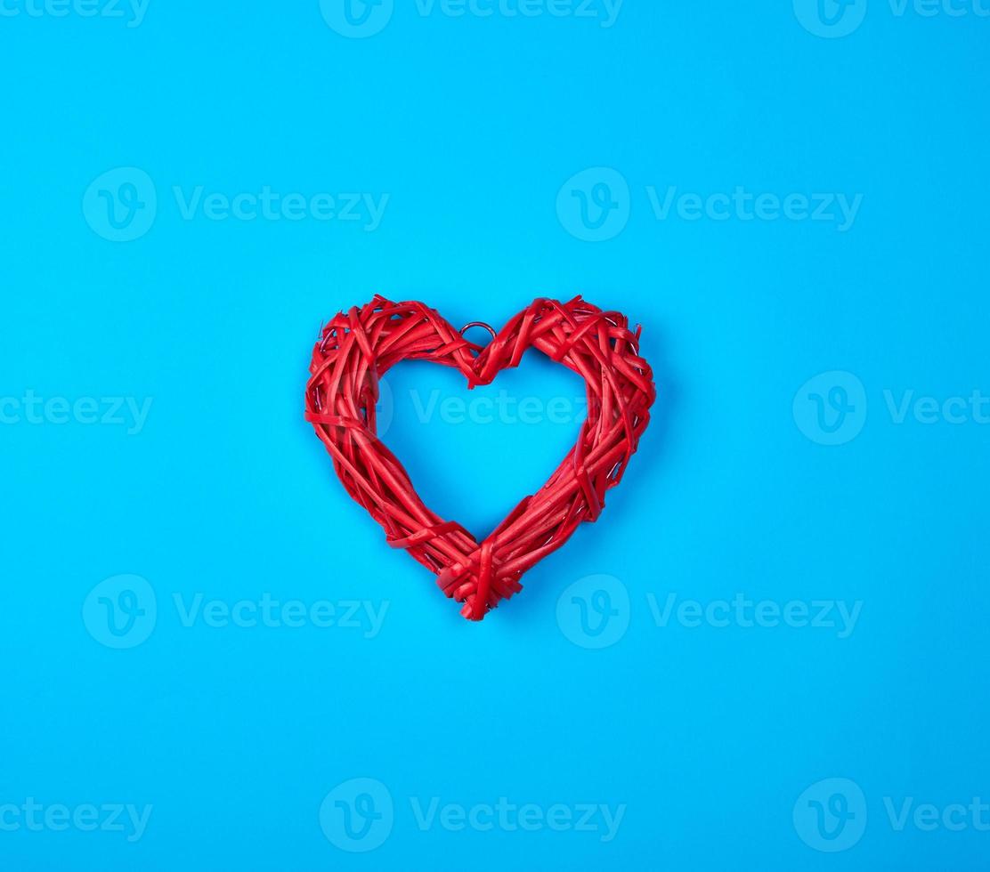 wicker red heart on a blue background photo