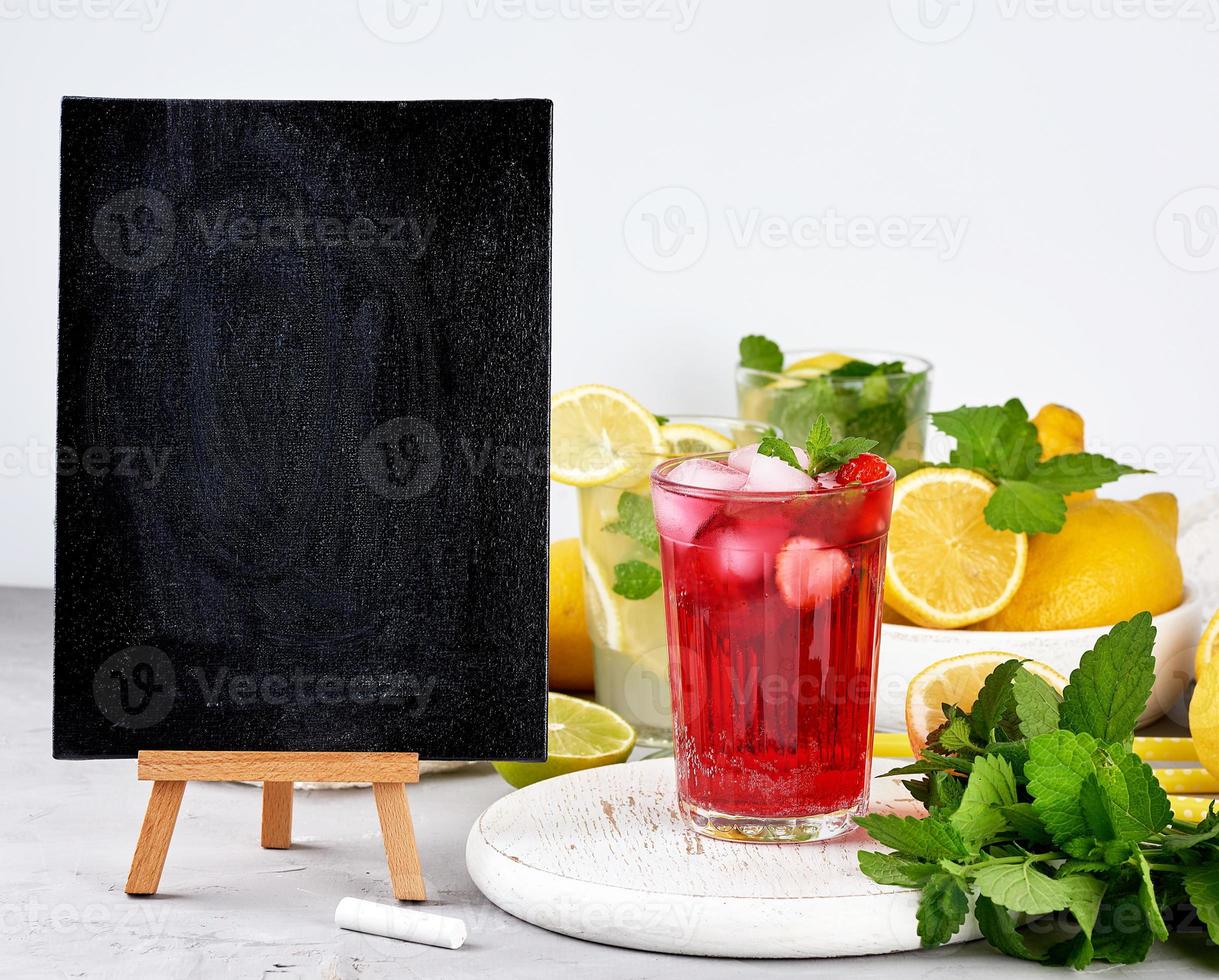 empty black chalk board for writing a summer drink recipe and a glass with berry lemonade photo