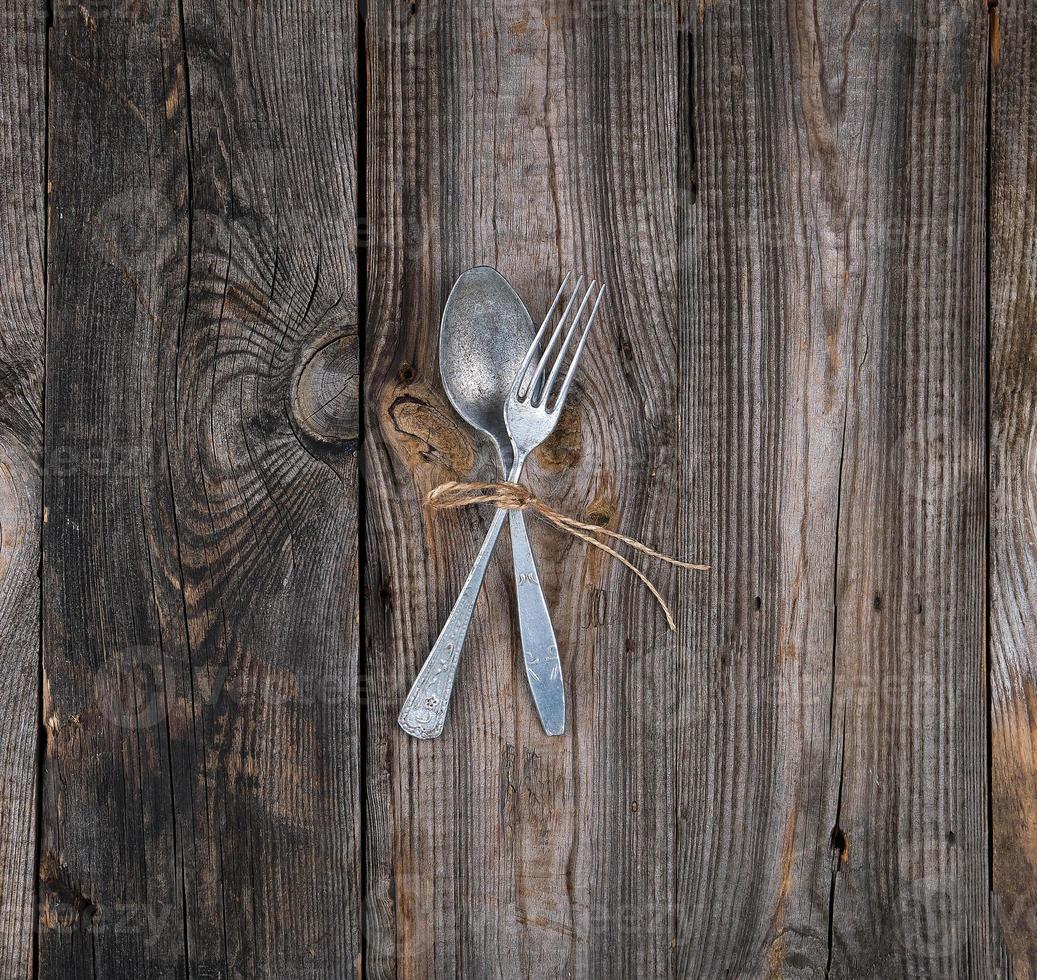 old metal fork and spoon tied with a brown rope photo