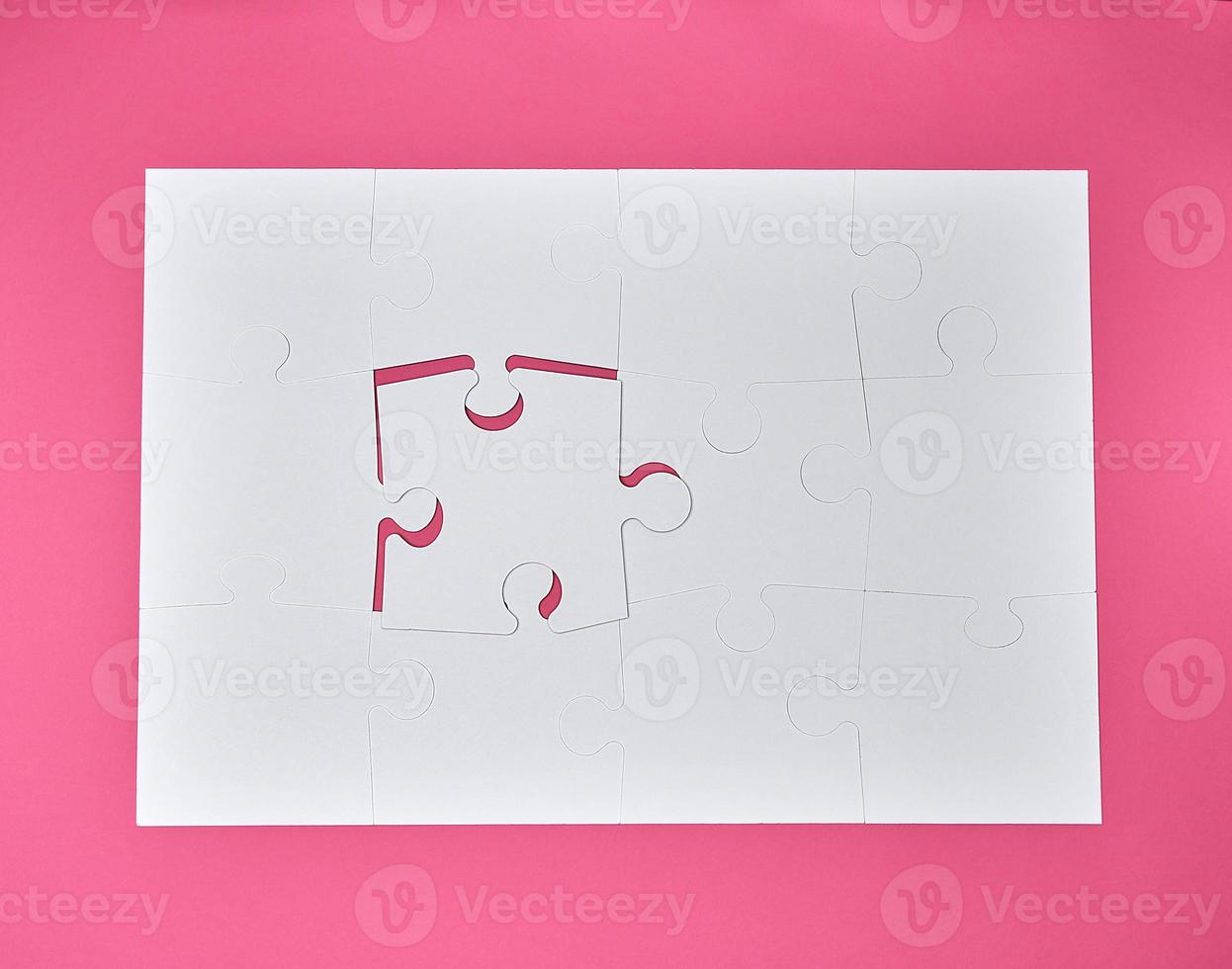 white large blank puzzles on a pink background photo