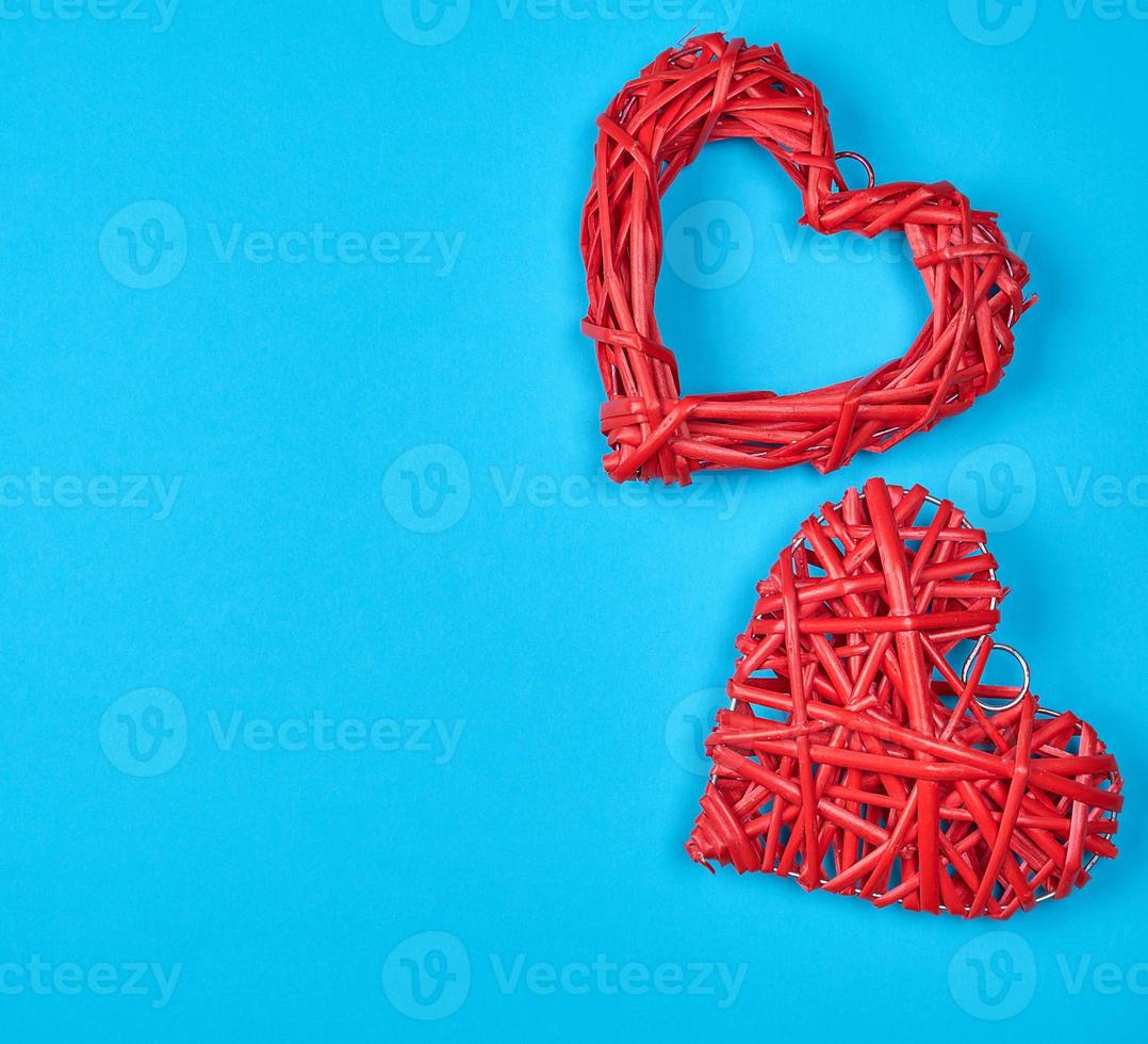 two wicker red hearts on a blue background photo