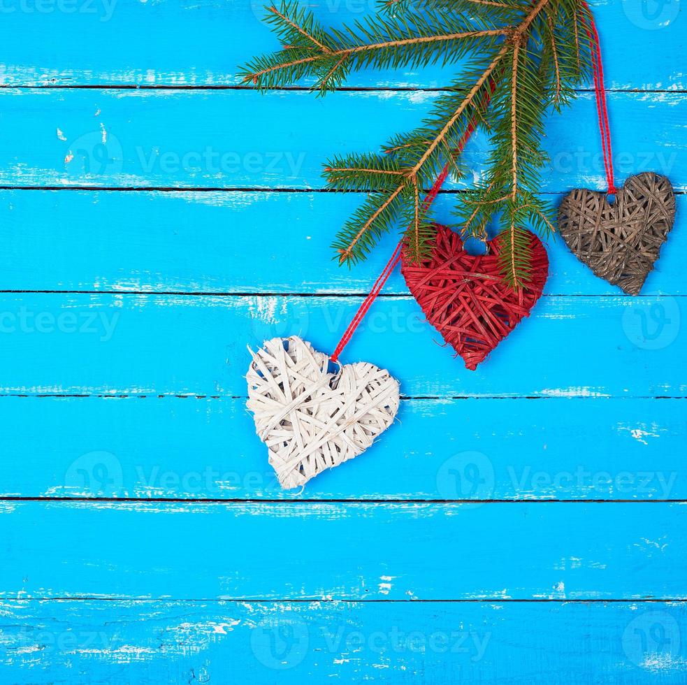 various wicker decorative hearts and green spruce branch photo