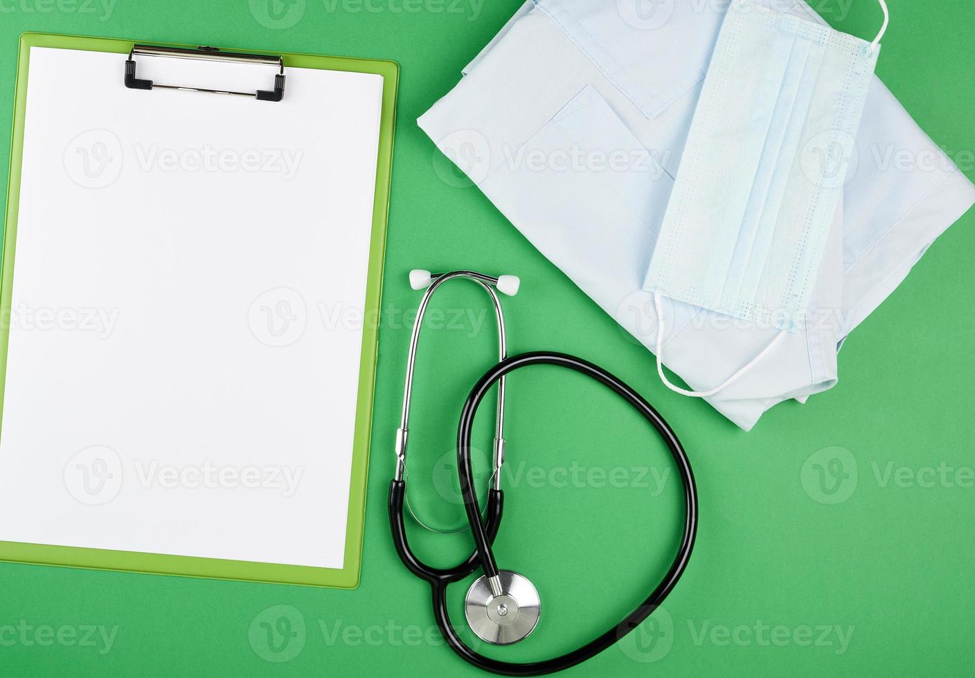 paper holder with empty white sheets, medical stethoscope photo