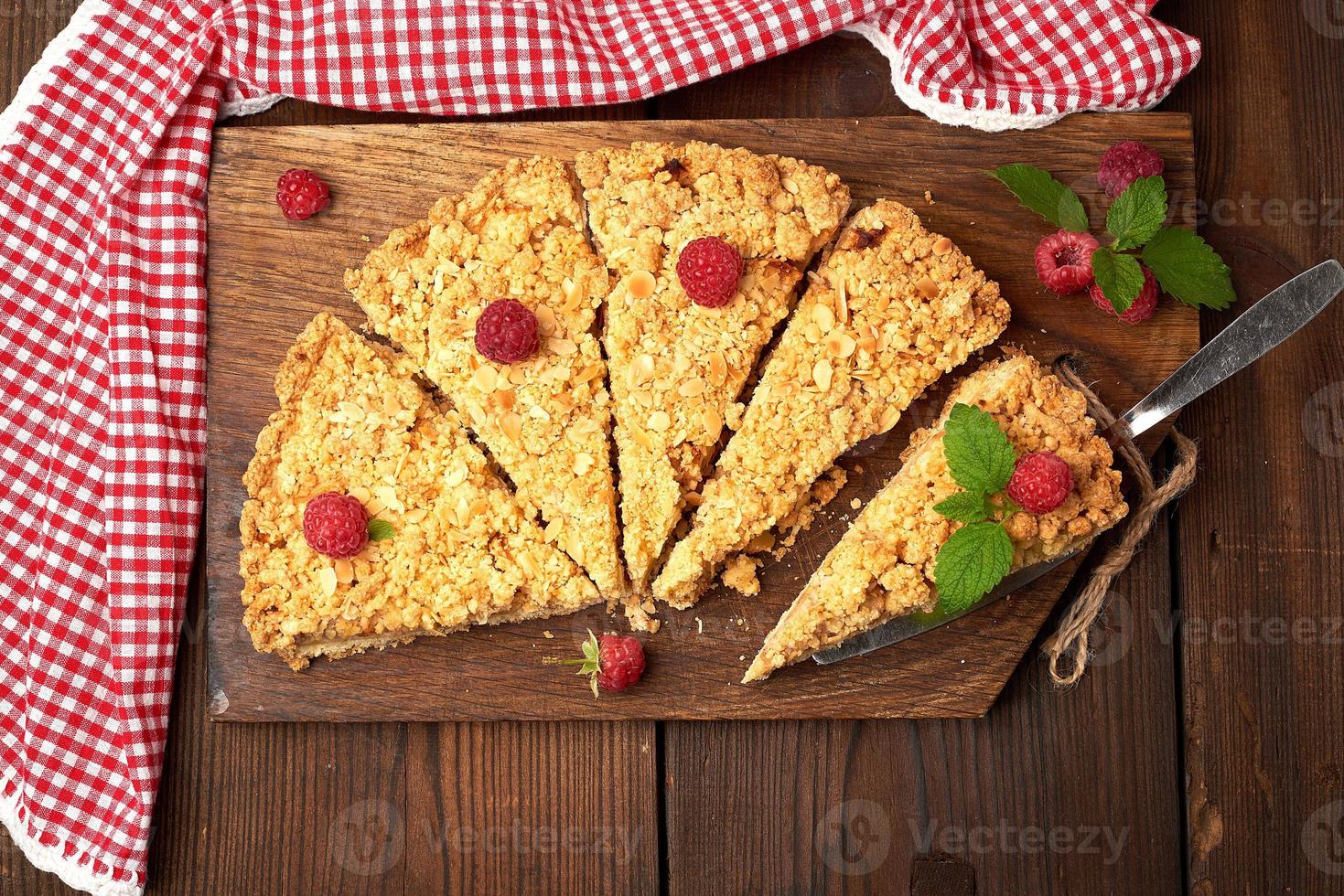 sliced triangular pieces of crumble pie with apples photo