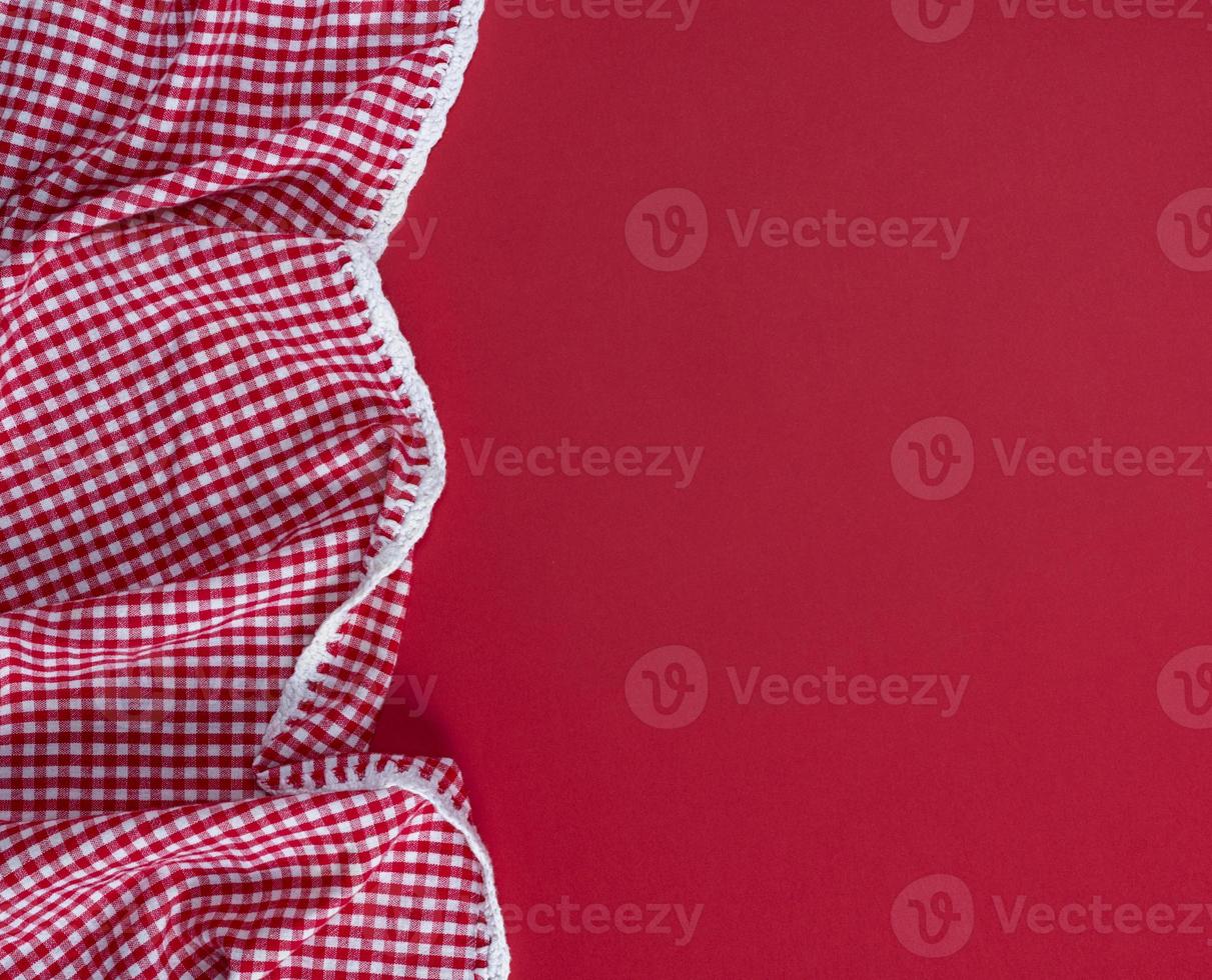 red textile towel in a white cell on a red background photo