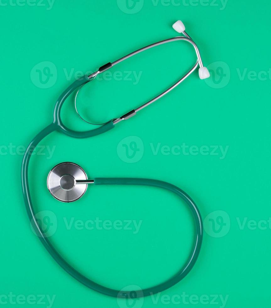 medical stethoscope on green background photo