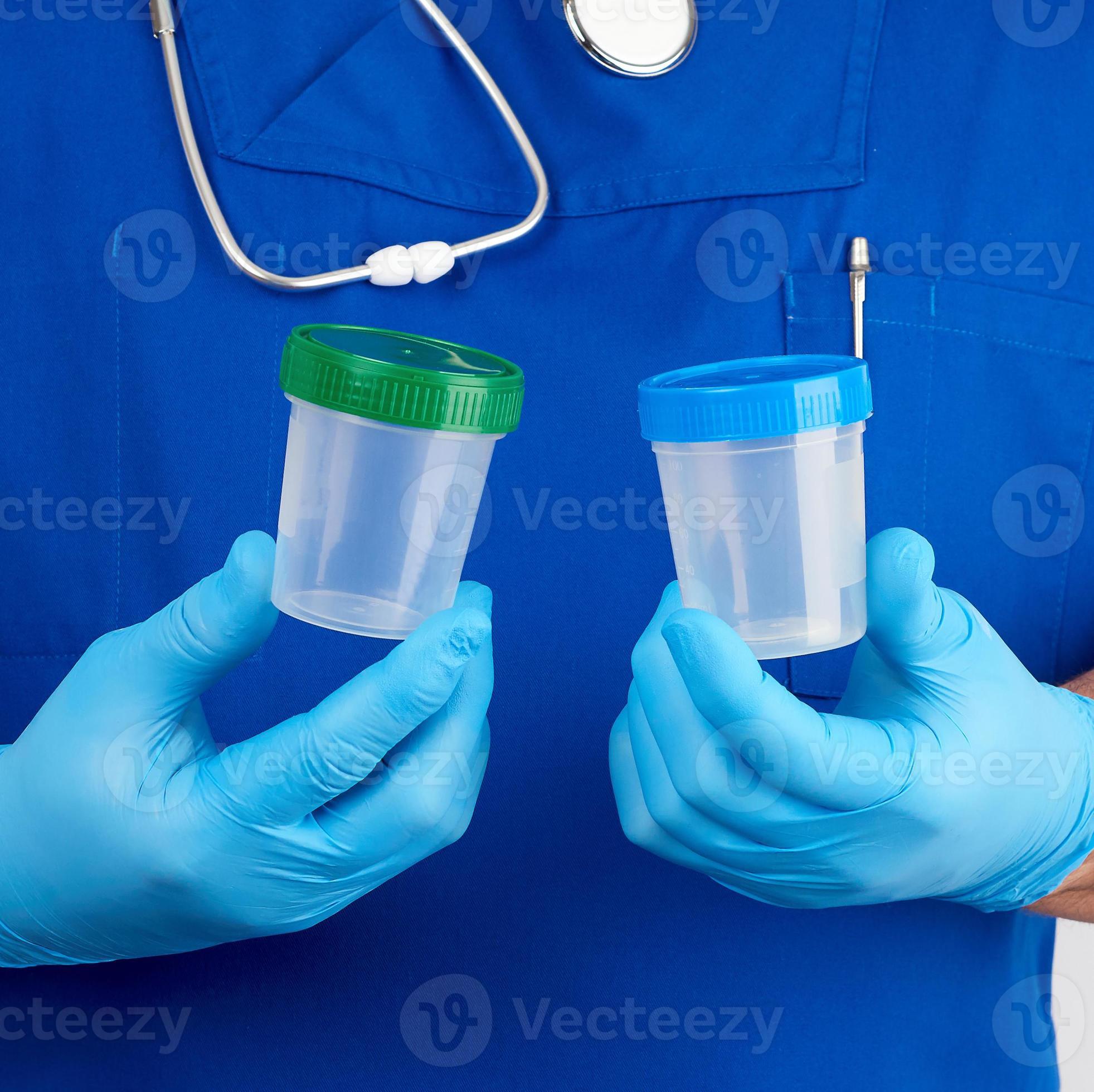 doctor in blue uniform and latex gloves is holding an empty plastic