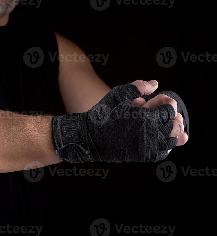 two men's hands wrapped in black sports textile bandage photo