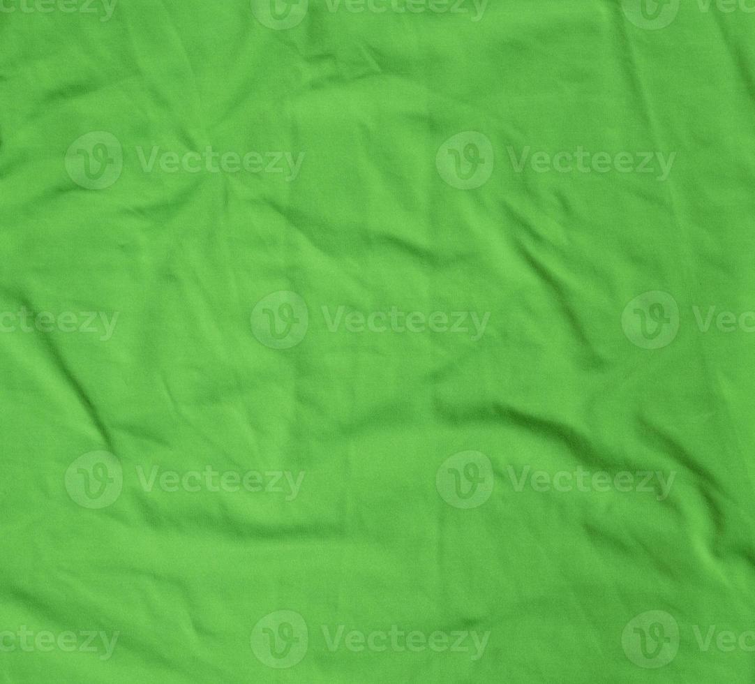green crumpled stretching soft fabric, full frame photo