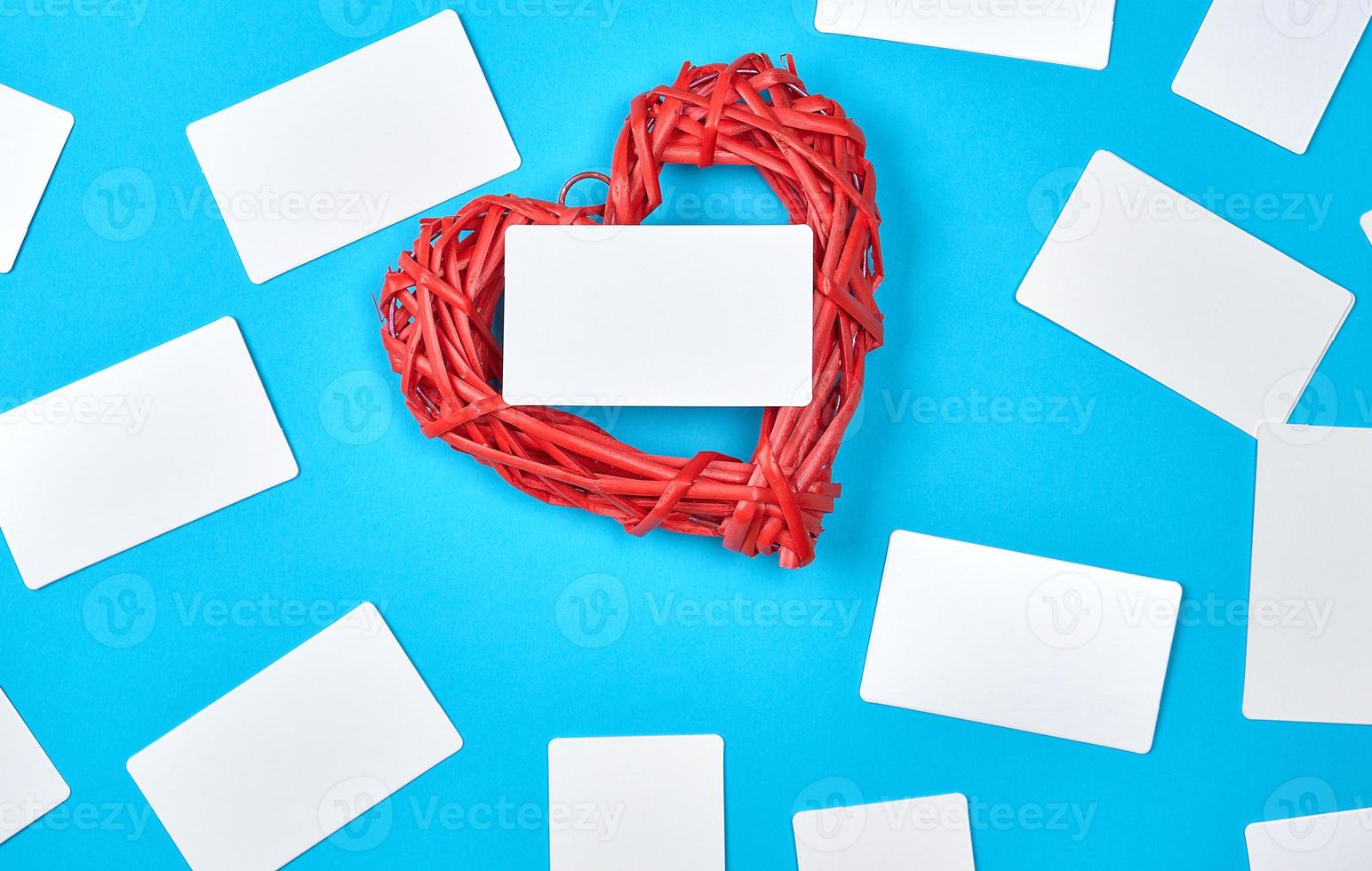 wooden wicker red heart and empty white paper business cards photo