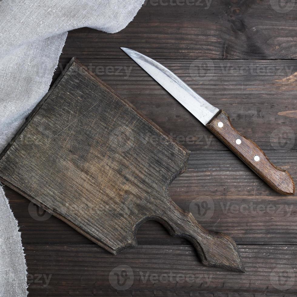 empty old brown wooden cutting board and knife photo