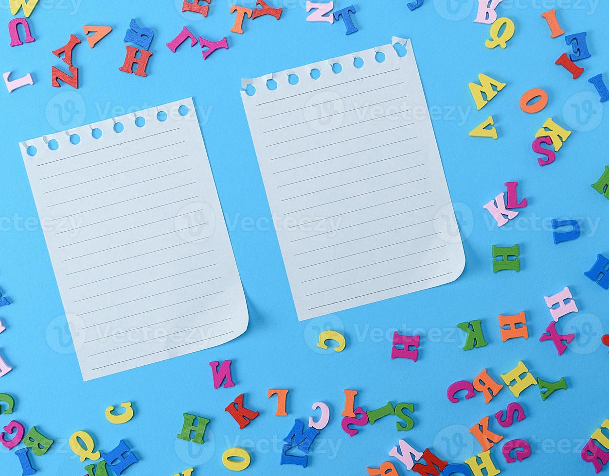 two white blank sheets in a line on a blue background photo