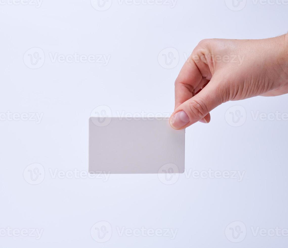 empty white paper business cards in a female hand photo