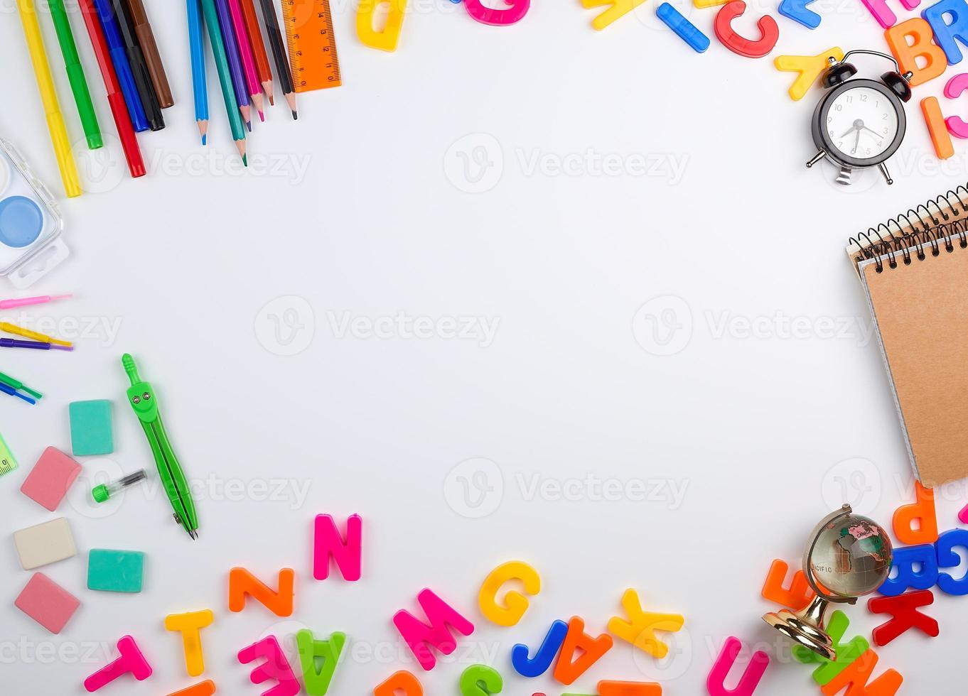 set of different school colorful items for learning at school on a white background, the middle space photo