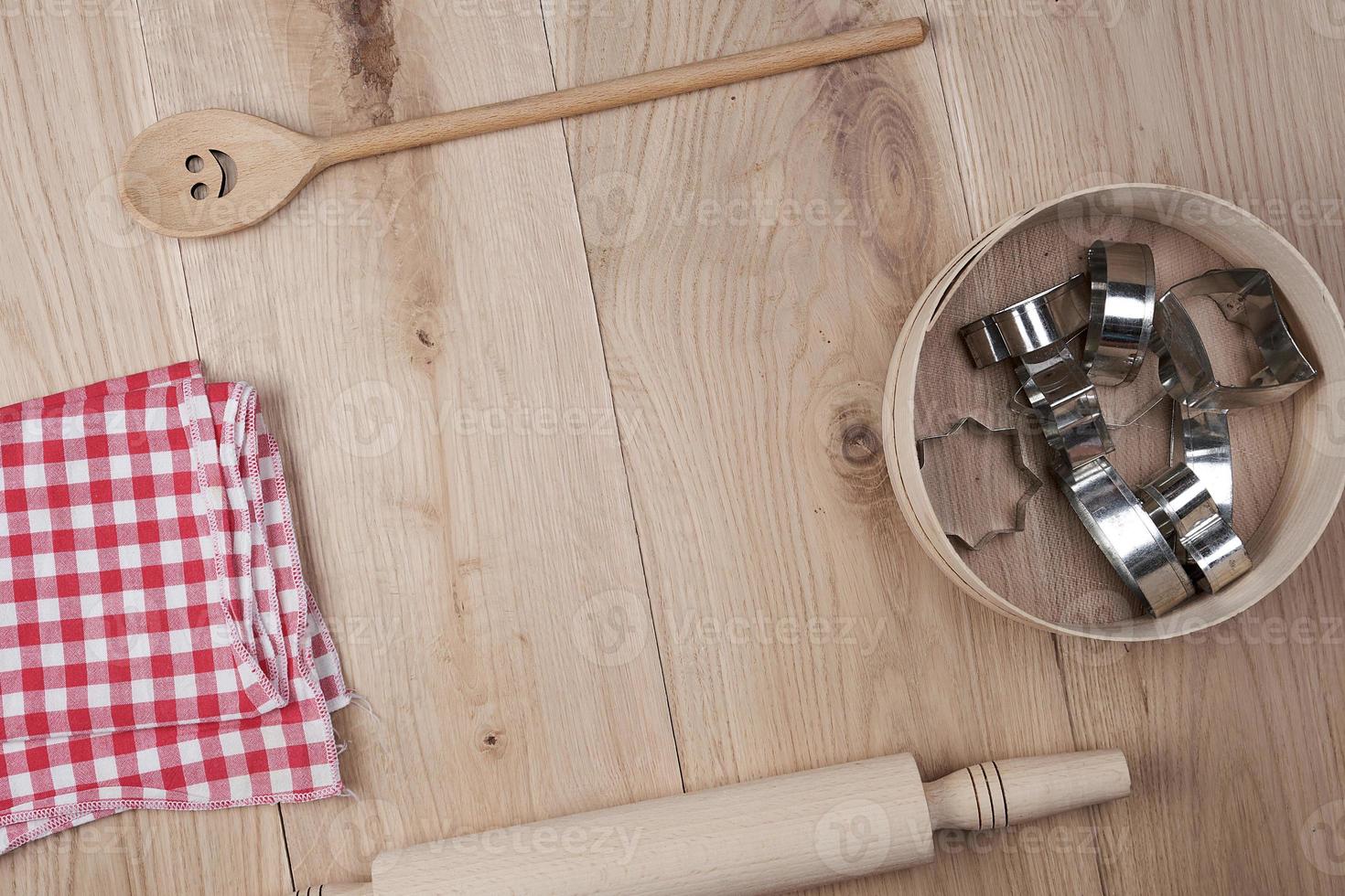 round wooden sieve with baking molds, top view photo