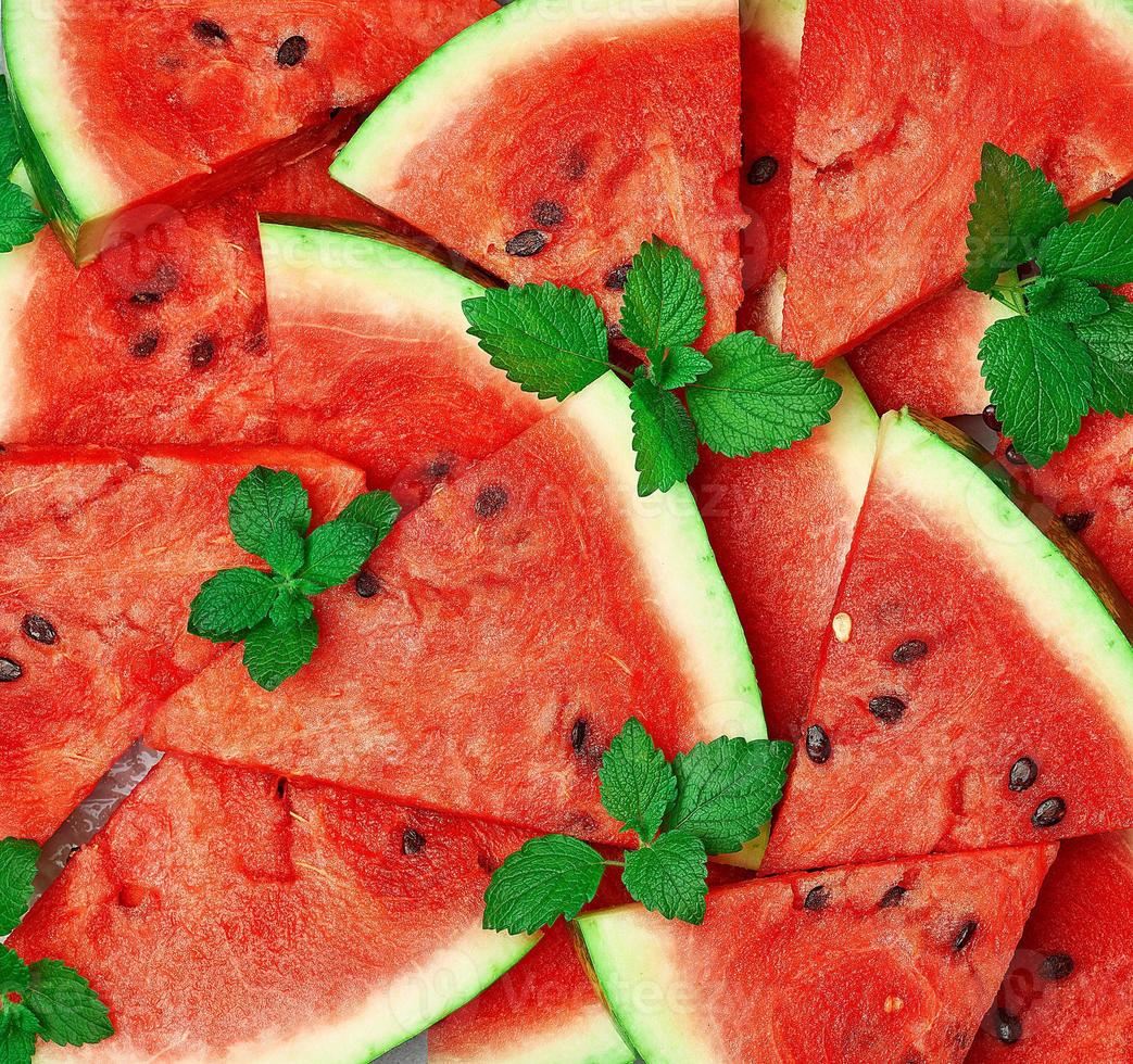 sliced triangular slices of ripe red watermelon with seeds photo