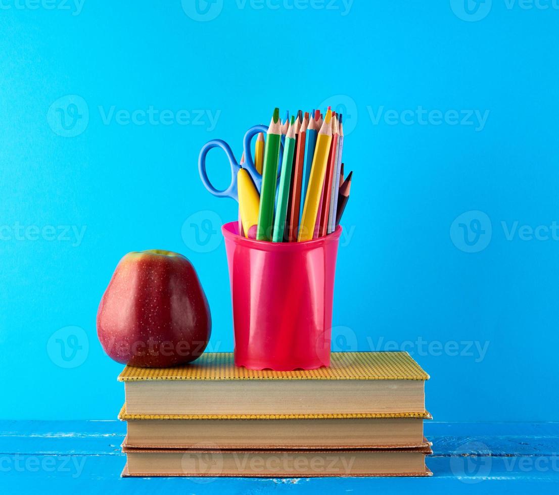 red apple and stack of books photo
